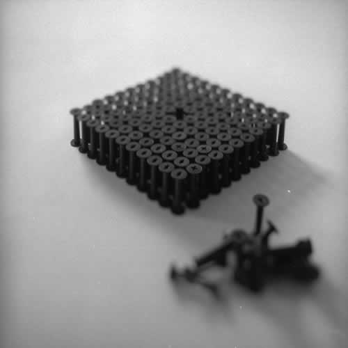 <body>
<p>This work was initially conceived of as a nod to the Terracotta Army of the Qin Emperor. Seeing that the film size ‘120’ for which these spools were manufactured is numerically 11²-1, I arranged this as a phalanx of 11 ranks of 11 and left the centre element out.</p>
<p>I thought I could also look at this omission as a flaw in the lattice and to see how the structure behaved over time, perhaps to model the corruption of power while I worked on the Dissent project with Chapel Arts. </p>
</body>
 Images Copyright Aldobranti® ©2008-'2025. All rights reserved.